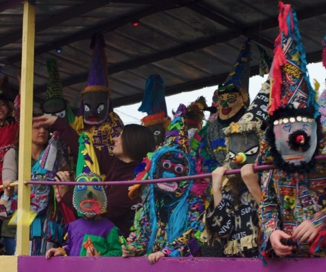 Mardi Gras riders in traditional dress on a parade float