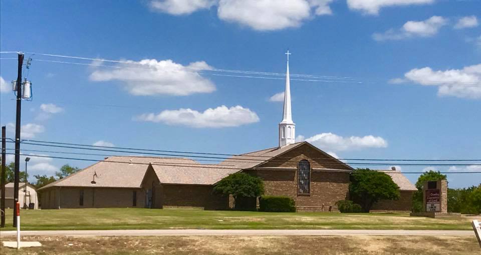 brick church building with steeple on top