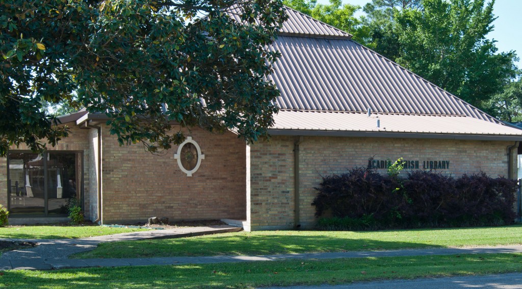 brick building with metal roof and oak tree branch in front of picture
