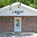 small brick building with library written on front