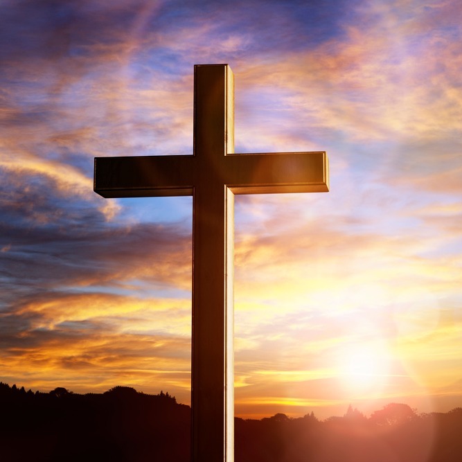 large cross with a colorful sky background