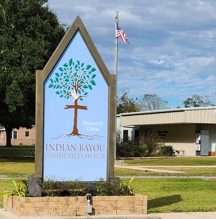 large church sign with a tree growing out of a cross