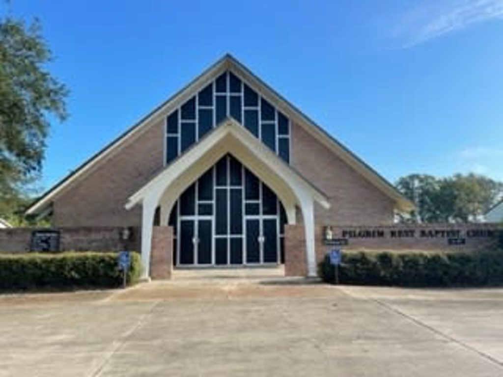 brick church building with large windows on the front