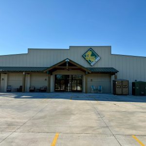 front of G & H outdoor store, metal building with wooden awning