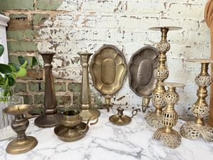 assorted brass candleholders and dishes