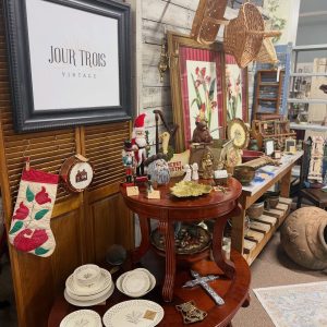 vintage display with Jour Trois sign in the foreground