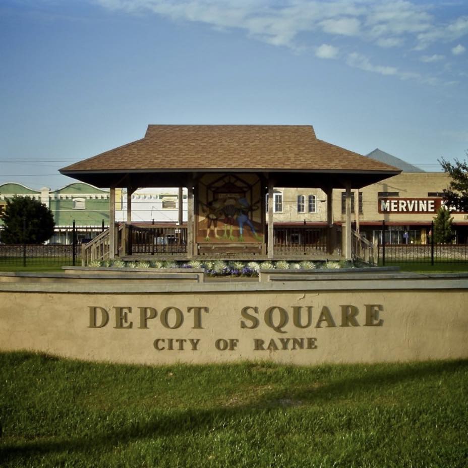 Covered area behind sign that reads Depot Square, City of Rayne