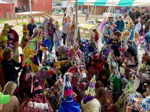 group gathered together in traditional Mardi Gras costumes