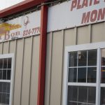 Metal building with signage across the top, C'est Bon restaurant in Mermentau