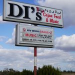 Raised sign against sky background, DI's Cajun Restaurant