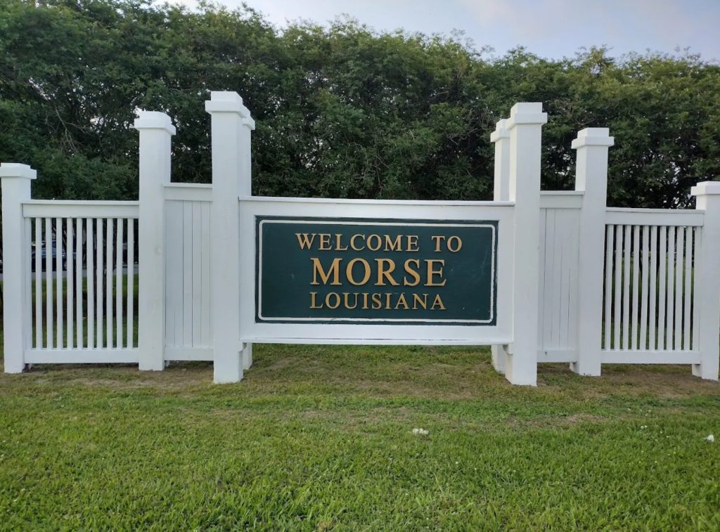 white fence with Welcome to Morse, Louisiana sign