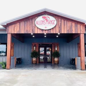front of building with Allons Mange sign