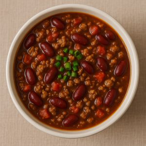 bowl of chili with beans, garnished with green onions