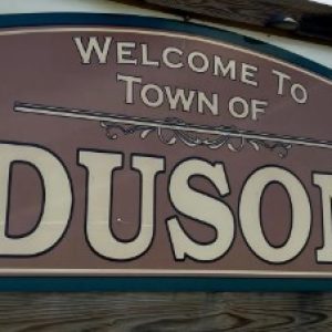 wooden sign that reads "Welcome to Town of Duson"