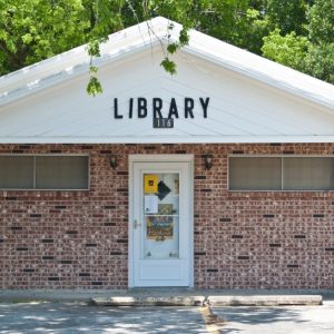 small brick building with library written on front