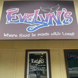 front of restaurant awning with Evelyn's logo painted on it