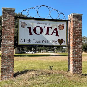 sign between brick columns, reads Iota in big letters, a little town with a big heart