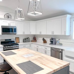 kitchen with white cabinets and large butcher-block island