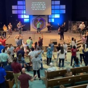 church members standing in worship, view from balcony above