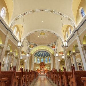 interior of ornate church with wooden pews and high ceilings