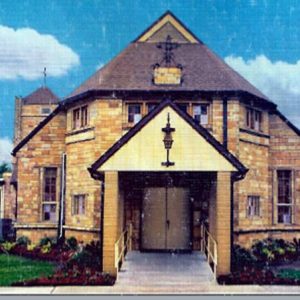 stone church building with cloudy, blue sky
